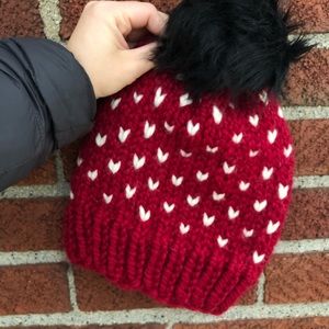 Hand knit hat with faux pompom